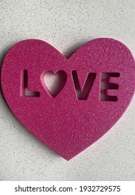 Colourful Magenta Pink And White Glitter Paper Cutout Heart Spelling The Words Love