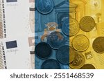 colourful national flag of canary islands on a euro money banknotes and coins background. finance concept. macro shot