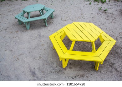 Colourful park benches in Tommy Thompson National park, Toronto. The benches are hexagonal shape, painted yellow and turquoise.
