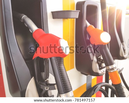 Colourful petrol pump fuel nozzles at Gas station service. Selective focus