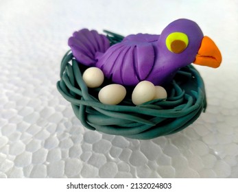 colourful plasticine birds nest isolated on white background.Handmade modeling clay sculpture.birds nest made with play dough.plasticine world.