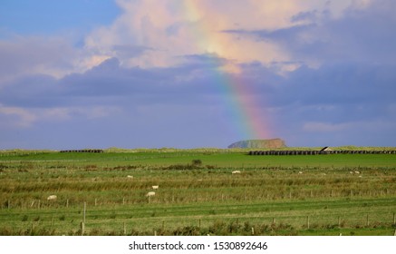 Colourful Rainbow In Irish Landscape Landing On A Large Rocky Outcrop