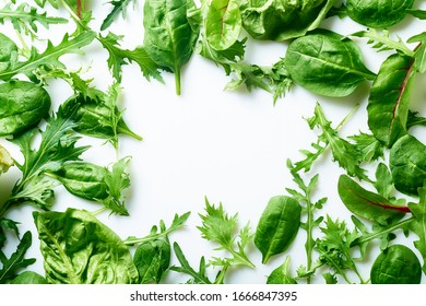 Colourful salad flat design on white background with copy space. Romaine, arugula, spinach and mizuna leaves flatlay. Vegan meal ingredients - Shutterstock ID 1666847395
