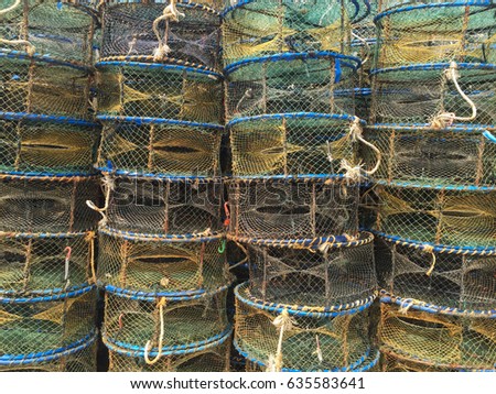Colourful stack of fish crates on a vesselat old village. Close up.