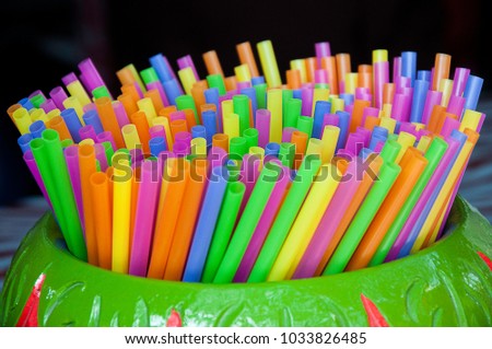 colourful straws many colours in small jar.