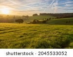 Colourful sunrise on a summer morning with a little fog on the ground and spectacular views over the Dutch hillside and the picturesque Buesdael castle dating back to the 14th century