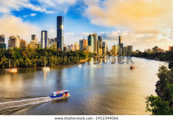 Colourful sunrise and soft morning sun light\
in Brisbane city over Brisbane river and high-rise CBD towers from\
elevation of Kangaroo point and Cliffs\
park.