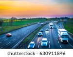 Colourful sunset at M1 motorway near Flitwick junction with blurry cars in United Kingdom.