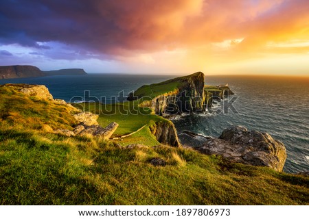Colourful sunset at Neist Point lighthouse in Scotland. Isle of Skye. 