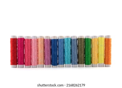 Colourful thread spools on white background with clipping path