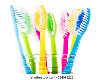 Colourful toothbrushes in a glass