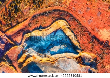 Colourful top down aerial view over open pit mine in Cobar copper town of Outback Australia.