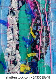 Colourful Torn Fabric Strips, Cords And Wool, Sewn Together In A Striped Pattern. Textile Art Textured Background. Vertical.