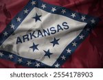 colourful waving flag of arkansas state on the old army khaki texture background. military concept. macro shot