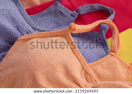 Colourful women's sports bra isolated on grey background.