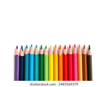 Colourful wooden colored pencils isolated with copy space. Spectrum coloring equipment flat lay on white background. Top view of creative art stationery. - Powered by Shutterstock