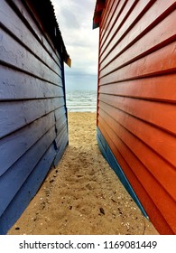 colourful wooden painted walls give perspective to the beach beyond 