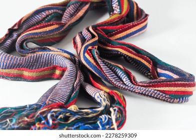 A colourful woven cloth in the form of a small shawl or scarf from the province of NTB on a white background. - Shutterstock ID 2278259309