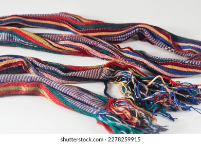 A colourful woven cloth in the form of a small shawl or scarf from the province of NTB on a white background. - Shutterstock ID 2278259915