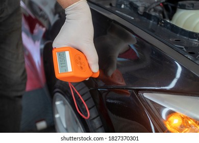 Colourist Man Selecting Color Of Car With Paint Matching Scanner