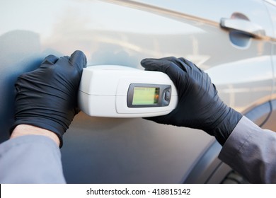 Colourist Man Selecting Color Of Car With Paint Matching Scanner 