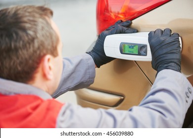 Colourist Man Selecting Color Of Car With Paint Matching Scanner