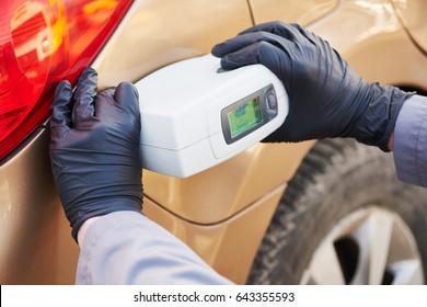 Colourist Man Selecting Color Of Car With Paint Matching Scanner