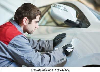 Colourist Man Selecting Color Of Car With Paint Matching Samples