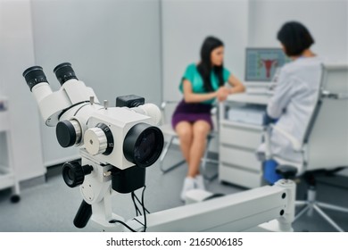 Colposcopy, examination of cervix. Colposcope close-up over gynecological consultation of woman patient with doctor ginecologist
