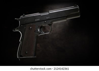 Colt 1911 Pistol On The Black Background.