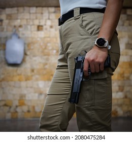 Colt Pistol Model 1911 In A Woman's Hand.