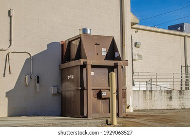Columbia County, Ga USA - 01 30 21: Wall trash compactor on a building 