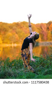 Columbia, MD - October 10, 2016: A Young Spiritual Women Enjoys Meditation And Nature At A Lake In The Fall.