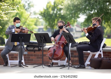 Columbia, MO / USA - June 21st, 2020: A Wedding Band Wears Masks While Playing During An Outdoor Ceremony During A Covid 19 Coronavirus Wedding In Missouri.