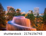 Columbia, South Carolina, USA downtown skyline and park at dusk.