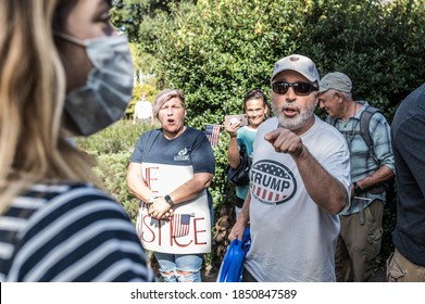 Columbia, South Carolina - USA - November 7, 2020: Trump supporters clash with anti-Trump protesters as they march around the South Carolina State House in protest of Joe Biden's election win.
