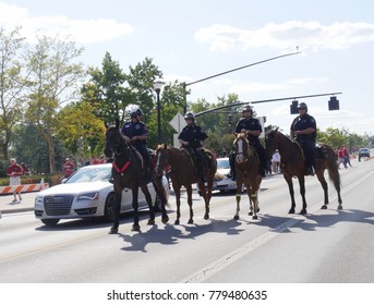 COLUMBUS, OHIO—SEPTEMBER 2017:  Four Policemen Diring Horses Keep The Traffic In Place Before A Football Game In Columbus, Ohio.