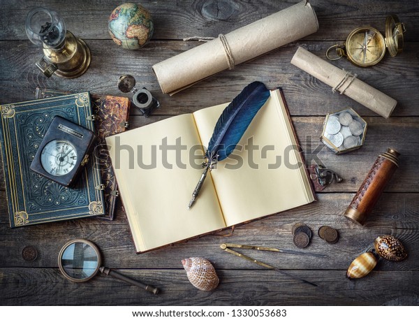 \
Columbus Day, exploration and nautical theme vintage background.\
Globe, telescope, lamp, divider, old coins, shell, map, shell,\
book, compass, hourglass, quill pen on wood desk.\
