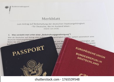 COLUMBUS, GEORGIA USA - 04-18-2019 
German And American Passport. Backdrop: Form For Permission To Retain German Citizenship.