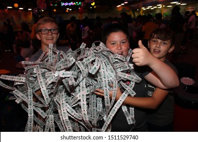 Columbus, Ohio September 16, 2019: Kids Playing Arcade Games At Local Skating Rink, With Lots Of Winning Tickets.