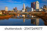 Columbus Ohio Skyline, Skyscrapers, and Landmark Buildings, USA: A vibrant tranquil beauty over the serene Scioto River water and green space in autumn