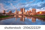 Columbus, Ohio, USA. Cityscape image of Columbus, Ohio, USA downtown skyline with the reflection of the city in the Scioto River at spring sunset.