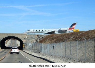 Columbus, Ohio/USA March 27,2019: John Glenn International Airport    Bridge Overpass Shows Plane On Runway Ready For Take Off.