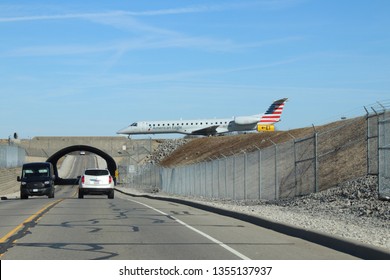 Columbus, Ohio/USA March 27,2019: John Glenn International Airport    Bridge Overpass Shows Plane On Runway Ready For Take Off.