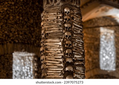 Column covered and decorated with human bones and skulls from The Chapel of Bones located in the city of Évora in Portugal. It was built in the 17th century at the initiative of three Franciscan monks