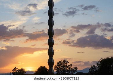 Column of infinity, Endless Column - concept. The sunset sky in the background.