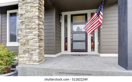 Column Porch Of Luxurious House With American Flag.  Northwest, USA