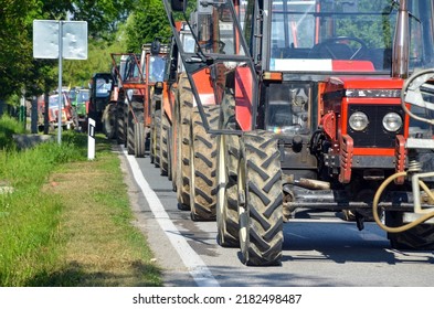 Column of tractors at protests. Farmers at demonstrations. Blocking the road with tractors. - Shutterstock ID 2182498487