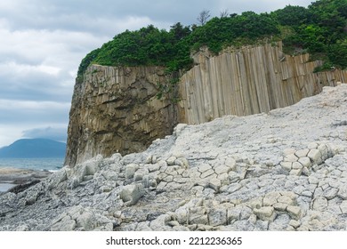 Columnar basalt rock, Cape Stolbchaty on Kunashir Island, in the foreground bases of lava basalt columns form a kind of pavement - Shutterstock ID 2212236365