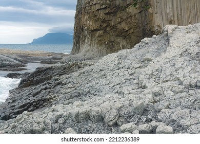 Columnar basalt rock, Cape Stolbchaty on Kunashir Island, in the foreground bases of lava basalt columns form a kind of pavement - Shutterstock ID 2212236389